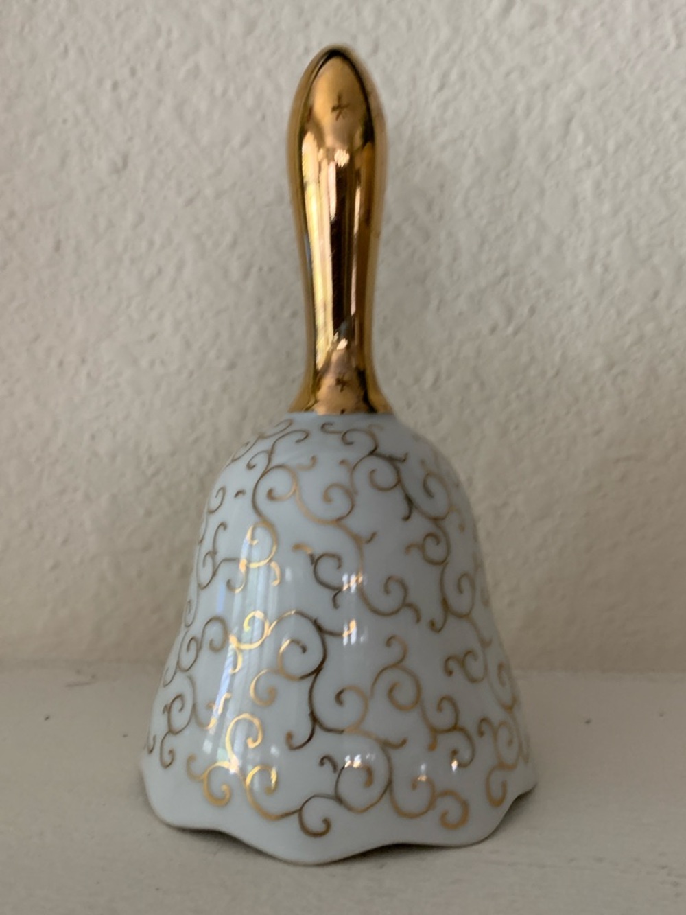 White Porcelain Bell with Gold Handle and Scroll Detail.  Vintage piece.